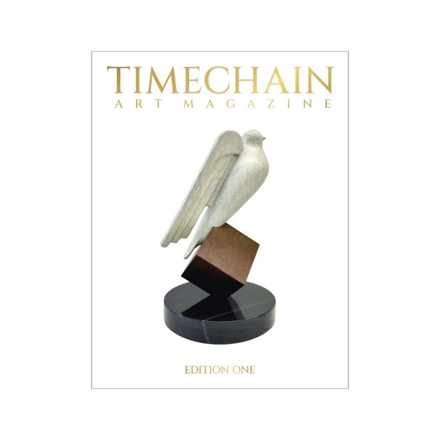 Timechain Art Magazine Edition One foil cover with gold lettering and cryptograffiti’s Hal Finney Freedom Prize sculpture.